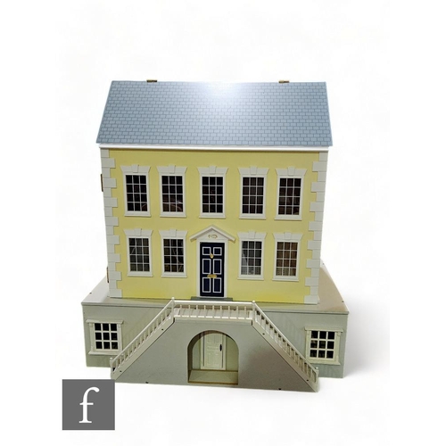 306 - A late 20th Century painted Georgian style wooden dolls house painted in yellow and grey with simula... 