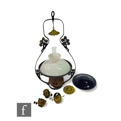 372 - A Victorian hanging lamp with opaque white shade above a copper reservoir within a floral pressed fr... 