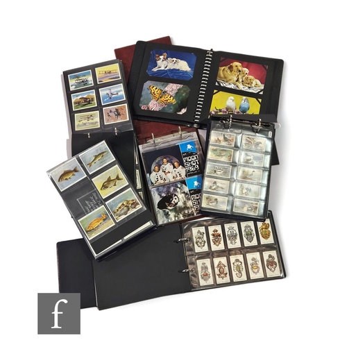 383 - A collection of four vinyl flip albums containing cigarette cards, part sets, also an album of 1960s... 