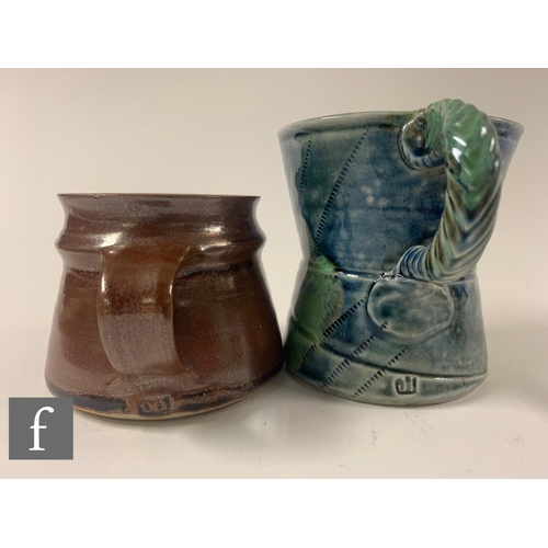 708 - A pair of studio pottery salt-glaze mugs by Jane Hamlyn, of waisted cylinder form with twisted loop ... 