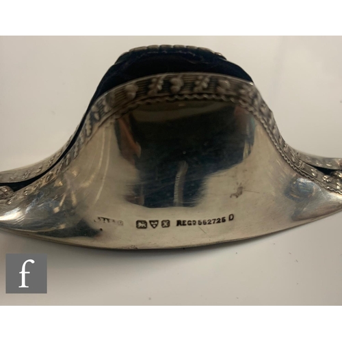 197 - A hallmarked silver pin cushion modelled as a Napoleon hat with acorn and leaf detail to borders, le... 