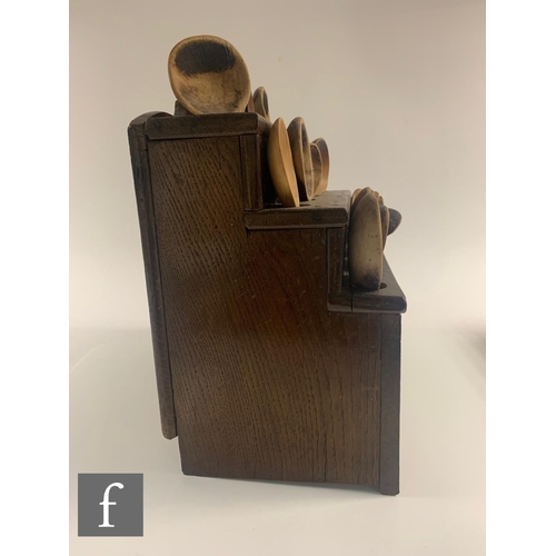 329 - A 19th Century oak Welsh three tier stepped spoon rack with later associated spoons, width 33cm.