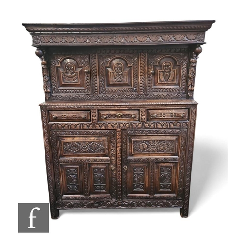 452 - A 17th Century style carved oak court cupboard, the upper section enclosed by three fielded panel do... 