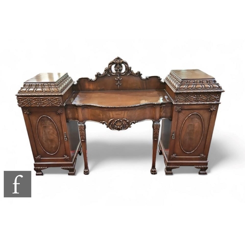 456 - An Edwardian carved mahogany pedestal sideboard, the serpentine front with a frieze drawer flanked p... 