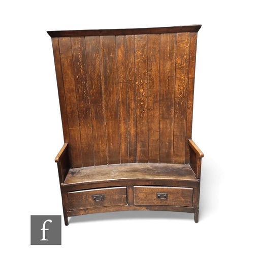 468 - An early 19th Century panelled curved oak Bacon settle with hinged panelled door back below a fluted... 