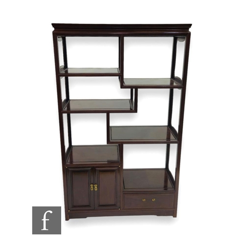 497 - A 20th Century Chinese Huang Huali style hardwood display cabinet, the six shelves over a two door c... 