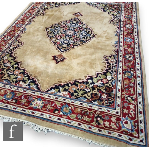 514 - A large 20th Century Persian style carpet, all over red and blue stylised design within a multi runn... 