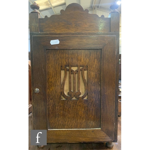 264 - A late 19th Century carved oak cased mantel clock with eight day movement striking on a gong enclose... 