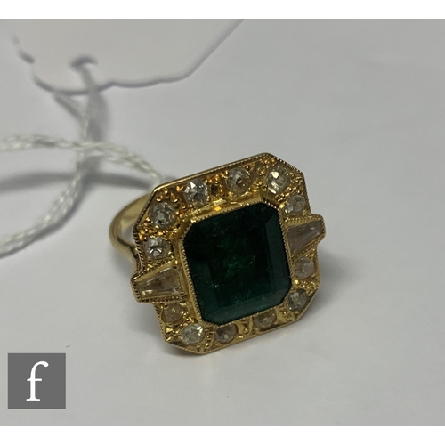 99 - An 18ct hallmarked emerald, diamond and paste set cluster ring, central canted rectangular emerald w... 