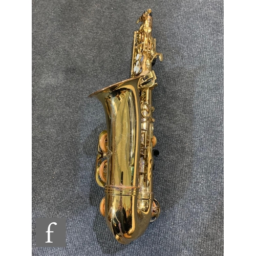 302 - A brass saxophone by Signature series, cased.