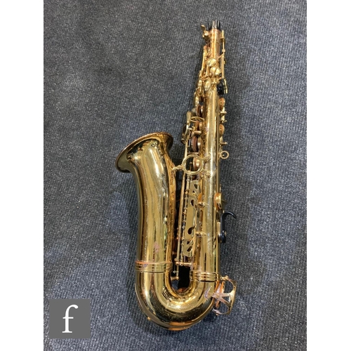 302 - A brass saxophone by Signature series, cased.