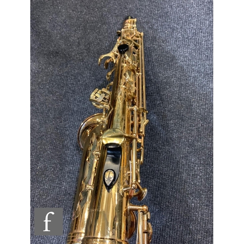 302 - A brass saxophone by Signature series, cased.