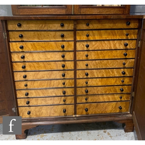 446 - A George III mahogany bookcase enclosed by a pair of diamond bar glazed doors below a fluted cornice... 