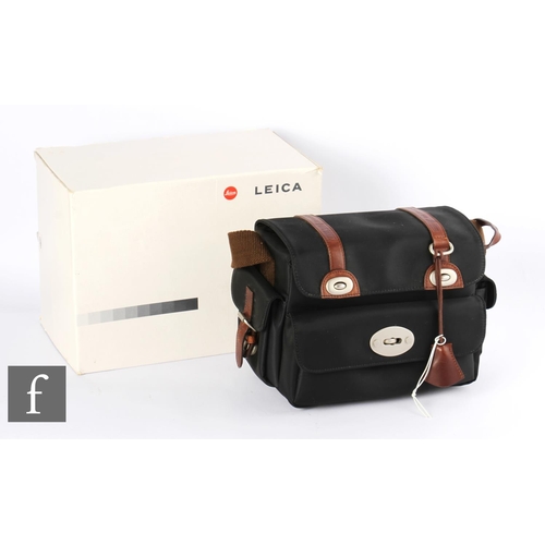 98 - A Leica camera bag, designed by Klaus Bree, black with tan leather straps, with dustbag and box.