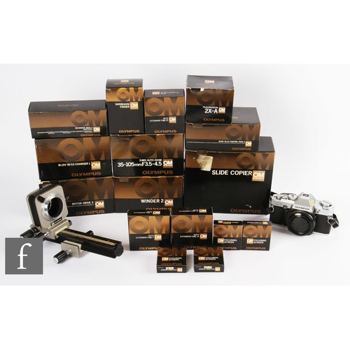 164 - An Olympus OM30 35mm SLR camera, with a collection of OM system lenses and accessories, to include 2... 