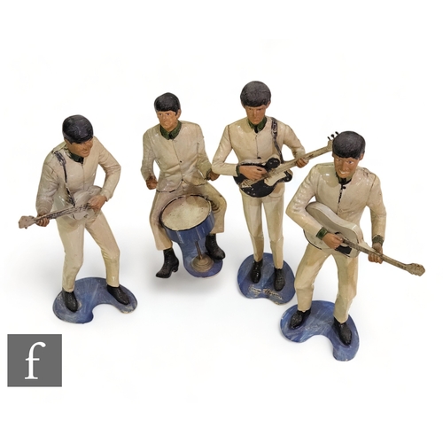 392 - A collection of four NEMS Enterprises Revell Inc plastic moulded figures of the Beatles John, Paul, ... 