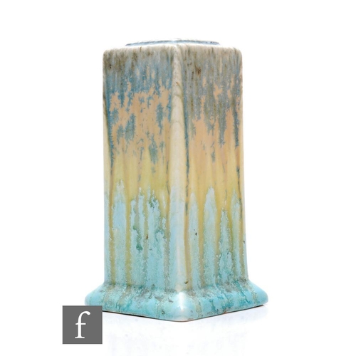 110 - Ruskin Pottery - A 1930s pottery vase of footed square sleeve form with lipped shoulder, decorated i... 