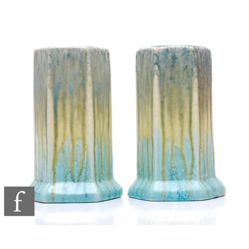 111 - Ruskin Pottery - A near pair of 1930s pottery vases, each of footed hexagonal sleeve form, decorated... 