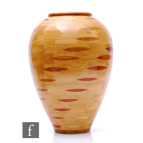 1110 - Bill Robinson - A contemporary segmented woodturned vase of ovoid form, decorated with a diagonal al... 