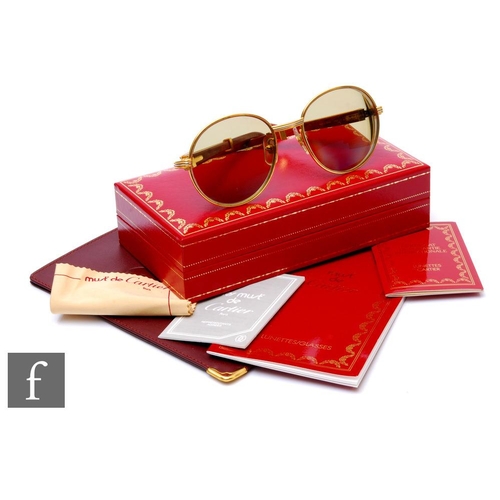 1113 - Cartier - A pair of full-rim Bagatelle series sunglasses circa 1993, 18K gold plated, Bubinga wooden... 