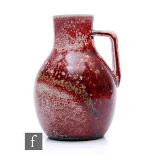 114 - Ruskin Pottery - A 1930s pottery jug of shouldered ovoid form with collar neck and angular handle, d... 