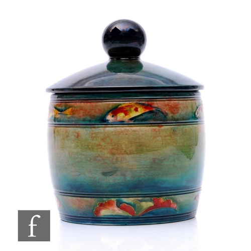 176 - William Moorcroft - Flambe Fish - A tobacco jar and cover circa 1935, of barrel form with bands of f... 