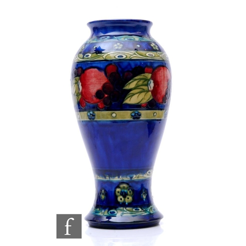 181 - William Moorcroft - Banded Pomegranate - A large vase circa 1925, the inverted baluster form tube li... 