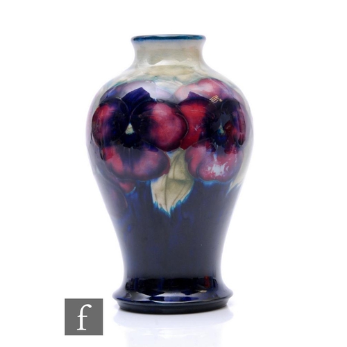 182 - William Moorcroft - Pansy - A vase of baluster form with narrow collar neck circa 1920, tubeline dec... 