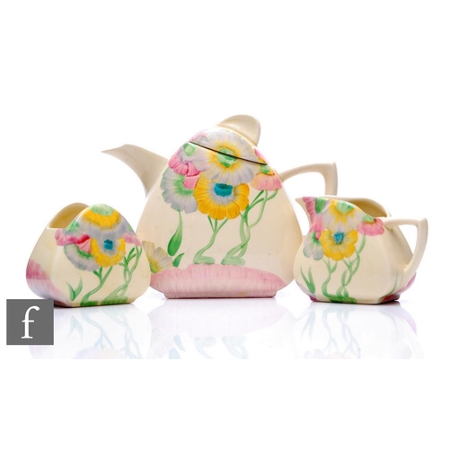 282 - Clarice Cliff - Pink Pearls - A Trieste shape teapot, milk and sugar circa 1934, hand painted with a... 