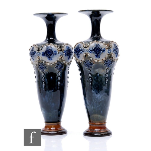 67 - Royal Doulton - A pair of early 20th Century stoneware vases of slender shouldered ovoid form with d... 