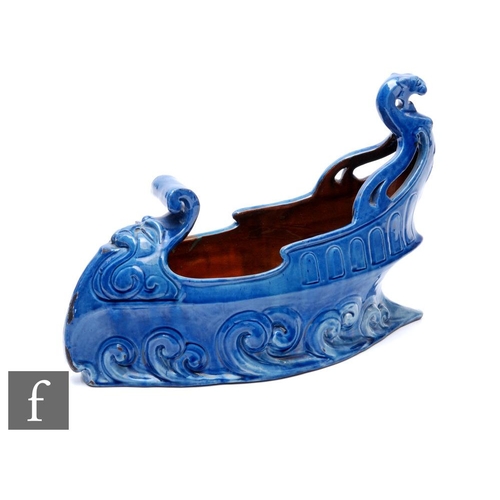 73 - Reginald Pearce - C.H Brannam - A table centre bowl modelled in the form of a galleon, with waves cr... 