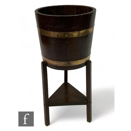 101 - Lister Woodcraft - An Arts & Crafts coopered barrel form wooden jardiniere stand, raised on thre... 