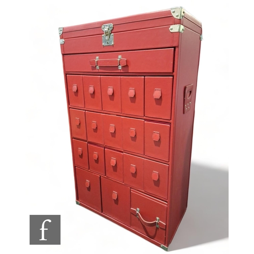 1122 - KARE design - A contemporary red leatherette chest of drawers, with metal mounts and an arrangement ... 