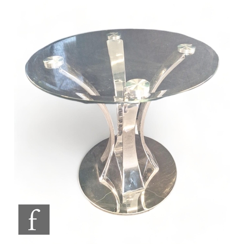 1117 - Unknown - A contemporary chrome plated coffee table with arched supports below a circular glass top.