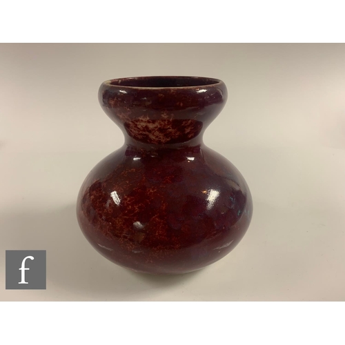 129 - Ruskin Pottery - A 1930s pottery vase of double gourd form decorated in a high fired glaze with purp... 