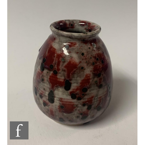 142 - Ruskin Pottery - A small 1930s pottery vase of tapered ovoid form with everted collar neck, decorate... 