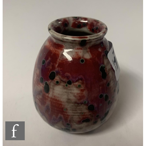 142 - Ruskin Pottery - A small 1930s pottery vase of tapered ovoid form with everted collar neck, decorate... 