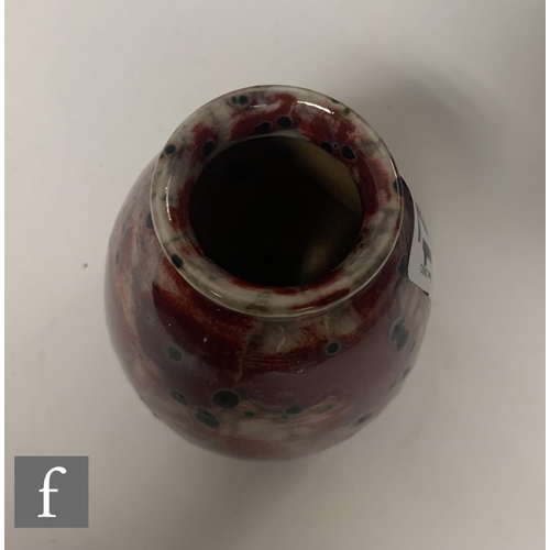 142 - Ruskin Pottery - A small 1930s pottery vase of tapered ovoid form with everted collar neck, decorate... 