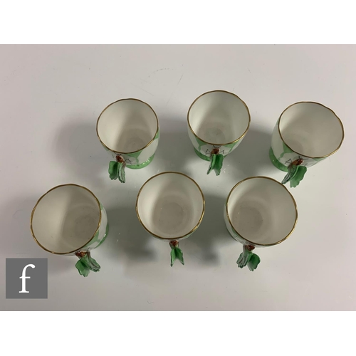 553 - Aynsley - An Art Deco butterfly and leaf moulded coffee set, pattern B1322, the handles modelled as ... 