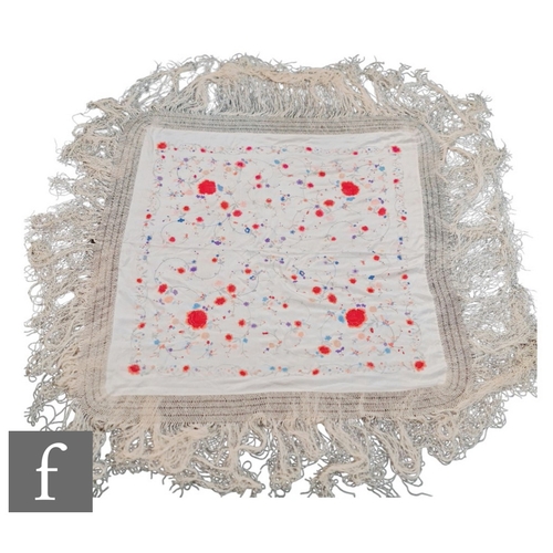 856 - A 1920s Chinoiserie embroidered Manila (or piano) shawl, the ivory silk ground with red, pink, blue ... 