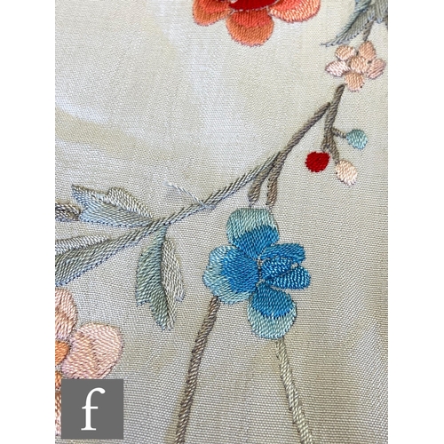 856 - A 1920s Chinoiserie embroidered Manila (or piano) shawl, the ivory silk ground with red, pink, blue ... 