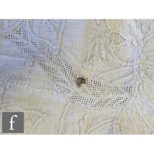 857 - A large late 19th to early 20th Century white cotton bedspread with a contrasting white floral desig... 