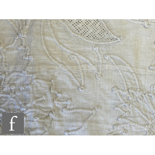 857 - A large late 19th to early 20th Century white cotton bedspread with a contrasting white floral desig... 