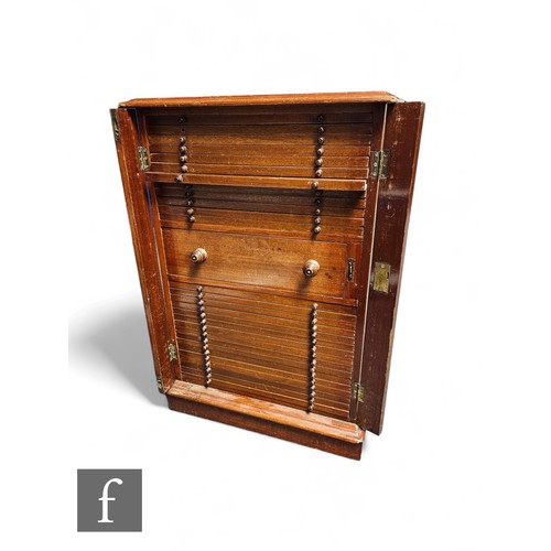 844 - An Edwardian mahogany coin cabinet, fitted with thirty drawers, centred by a deep drawer, turned woo... 