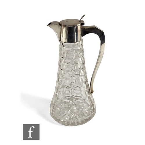 258 - A hallmarked silver and clear cut glass claret jug, the tapering glass body rising to a silver colla... 