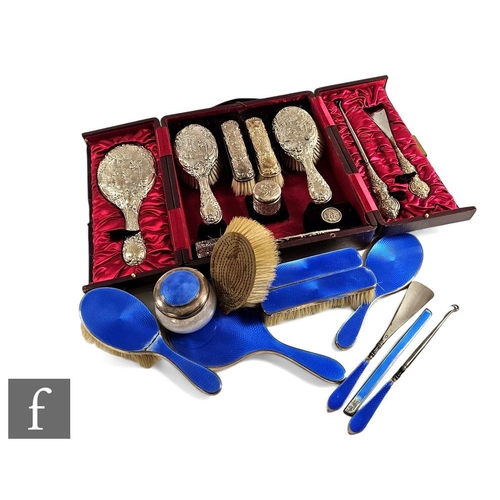 259 - An Edwardian hallmarked silver dressing table set comprising four brushes, hand mirror, button hook,... 