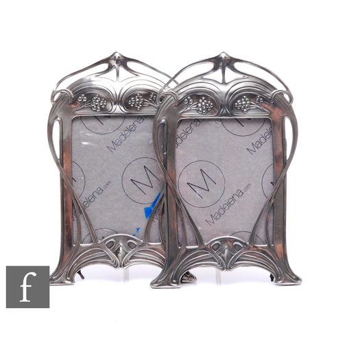 269 - A pair of WMF polished pewter shaped rectangular easel photograph frames, each with whiplash and ber... 