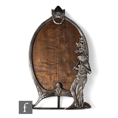 277 - A WMF polished pewter oval easel photograph frame with the study of a standing lady playing pipes un... 