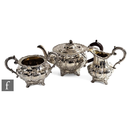 278 - A matched hallmarked silver three piece melon shaped tea set decorated with embossed and engraved ro... 