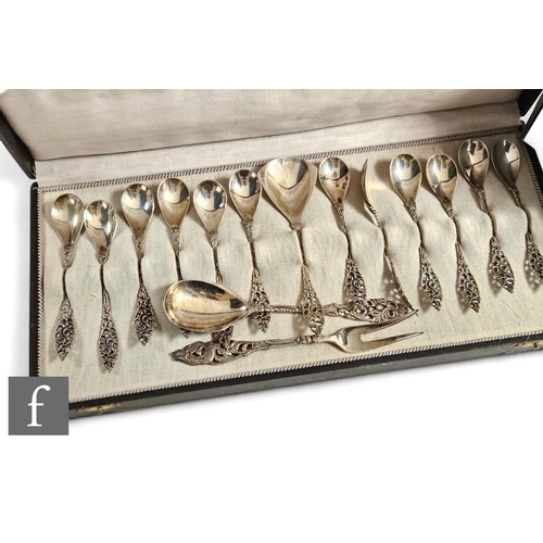 282 - A cased set of twelve continental white metal ornate teaspoons with a matched spoon and fork, total ... 